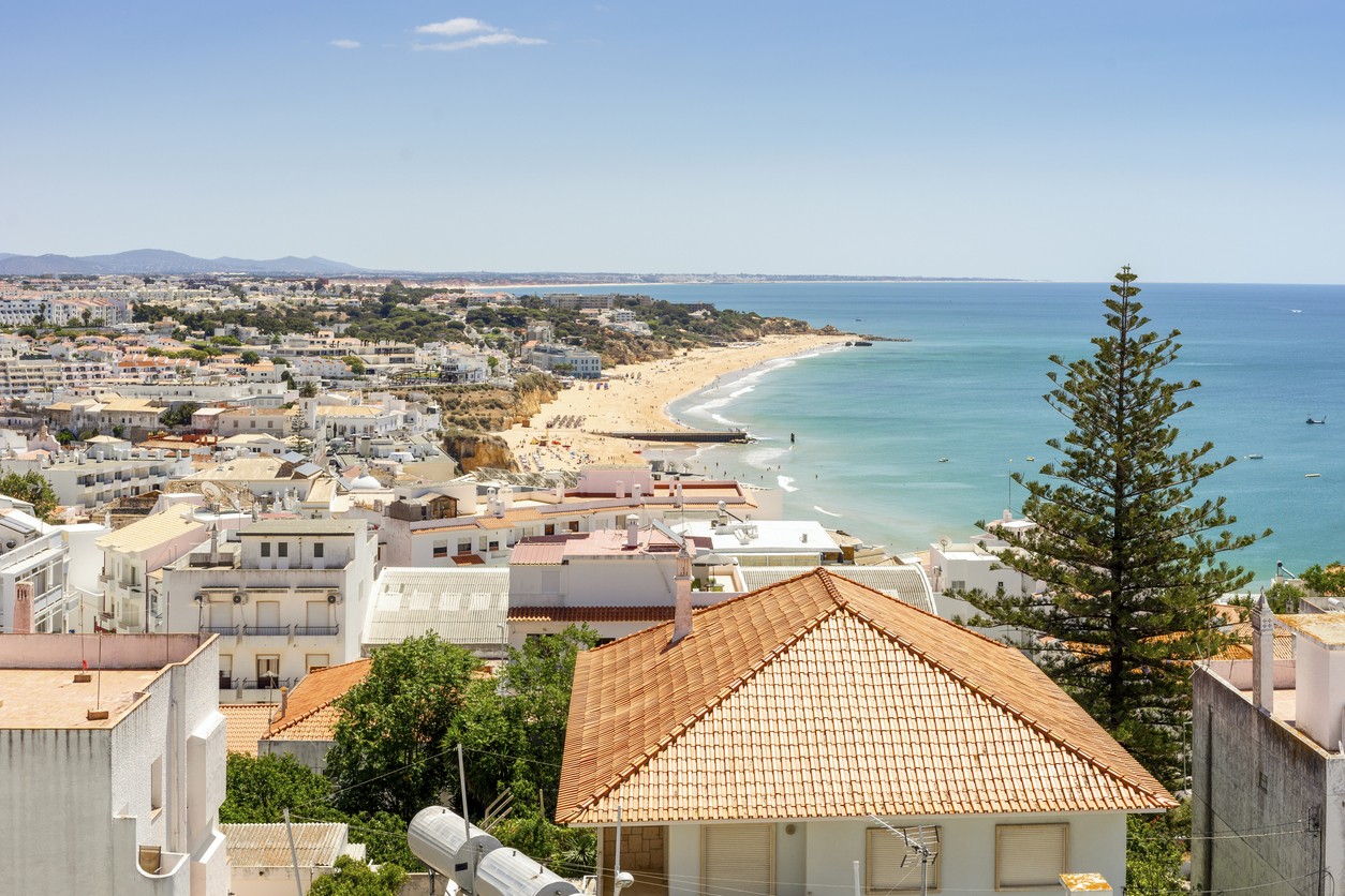 View of beautiful Albufeira with white architecture and sandy beach, Algarve, Portugal